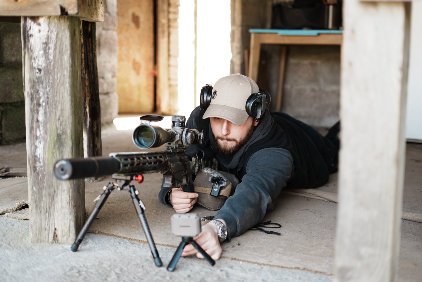 Max, LRT director and lead instructor, prone behind a suppressed precision rifle on the firing point.